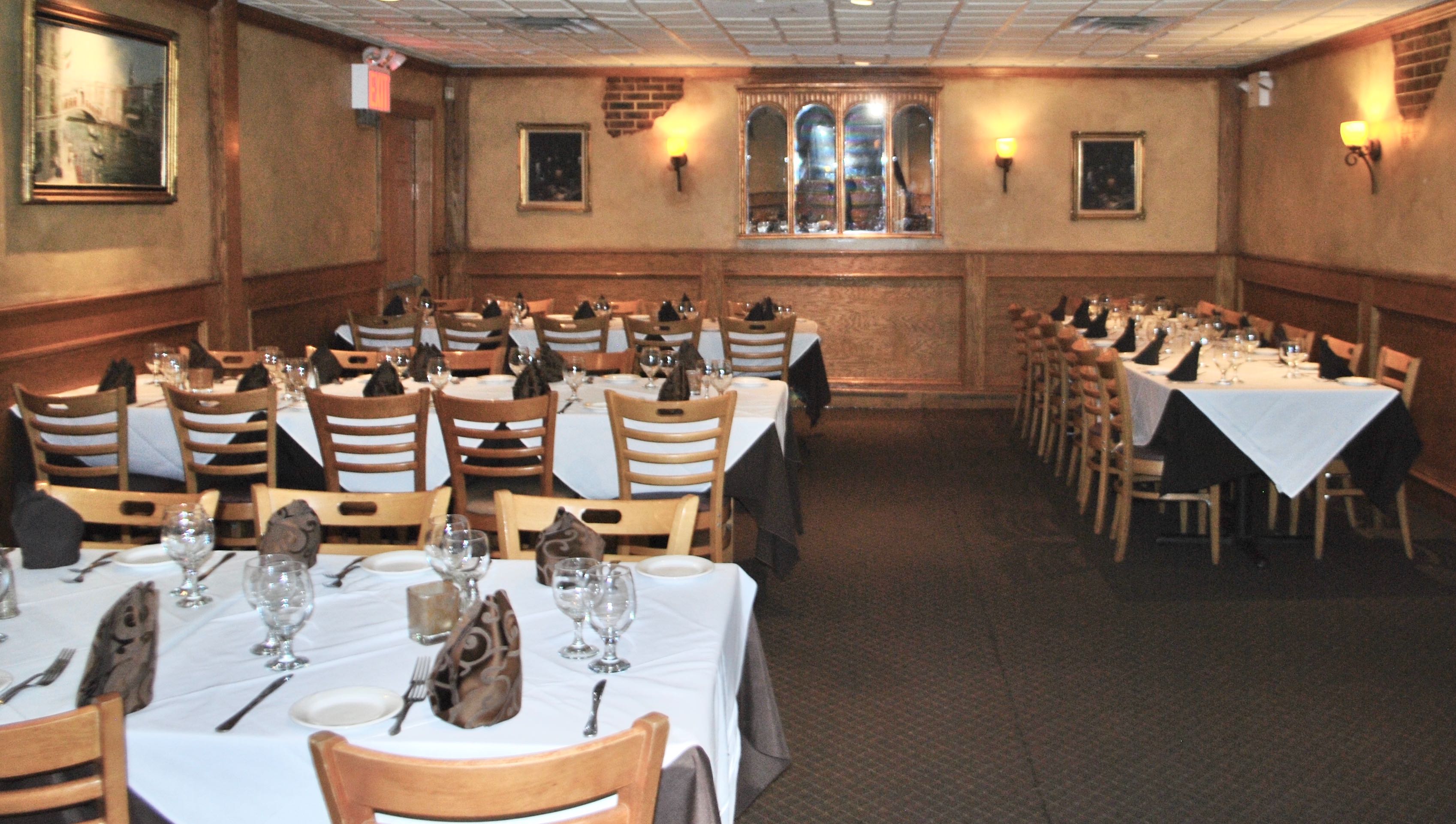 Private dining room at La Fontana Oakwood set with white tablecloths