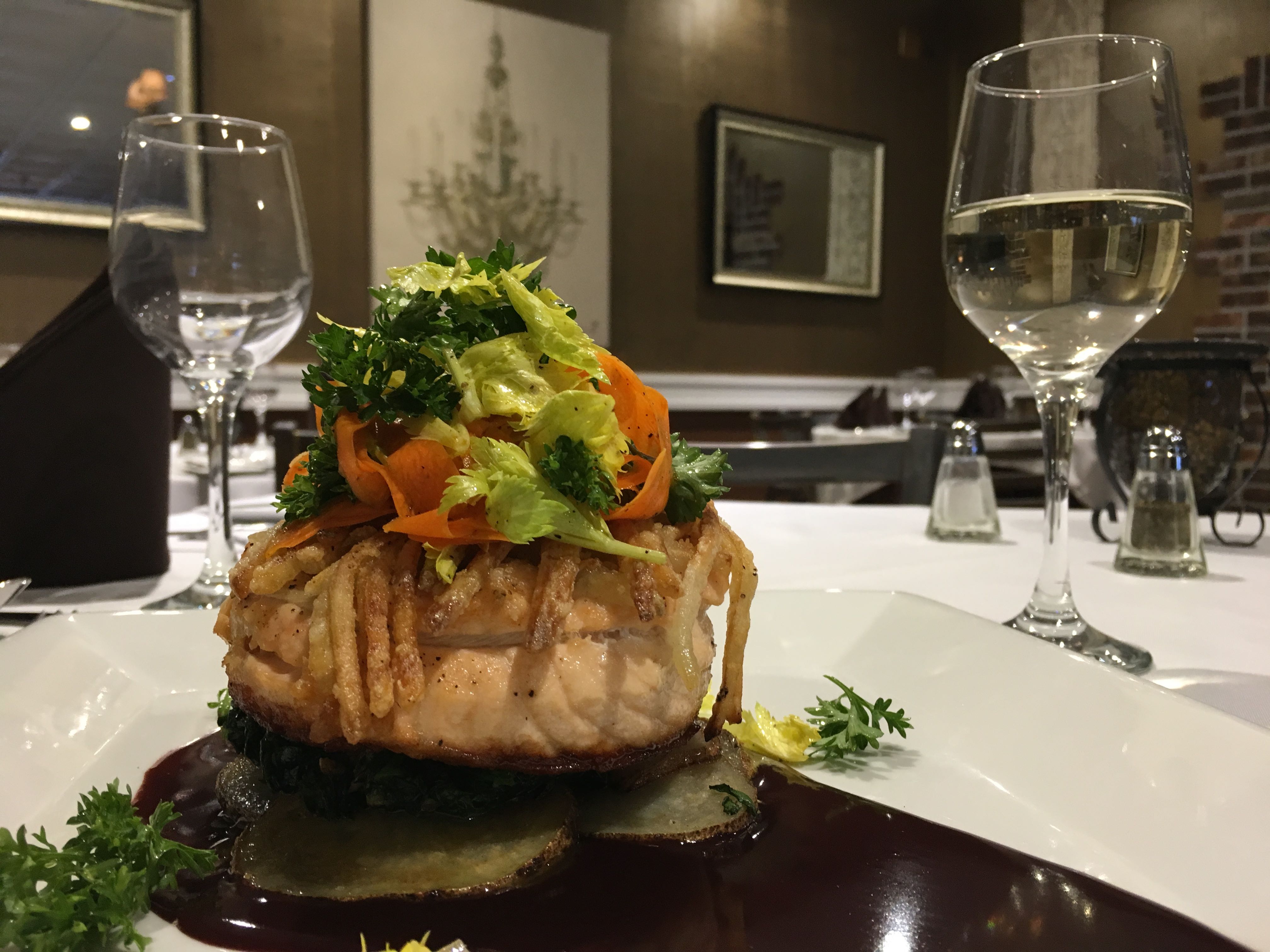 Fish with fresh vegetables served at a white-tablecloth Italian dinner
